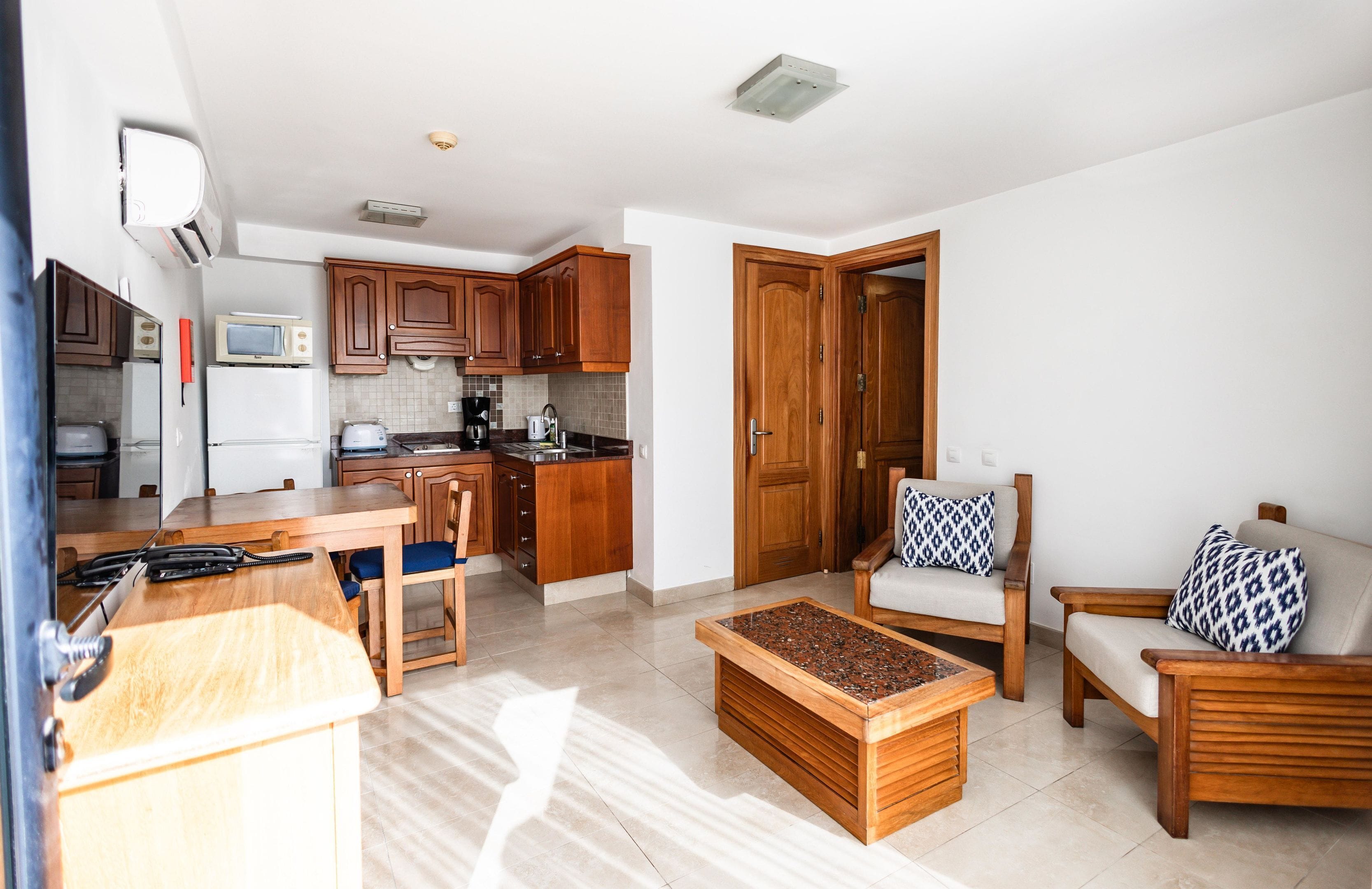 A compact living space with a kitchen, dining area, and seating area.