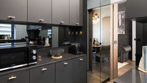 A modern kitchen with a microwave, toaster, and a bowl on the counter.