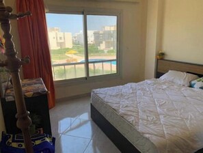 Enjoy a peaceful retreat with a view of the surrounding cityscape from this hotel room's large window.