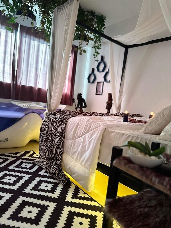 A bedroom with a canopy bed, a patterned rug, and a wall with geometric decorations.