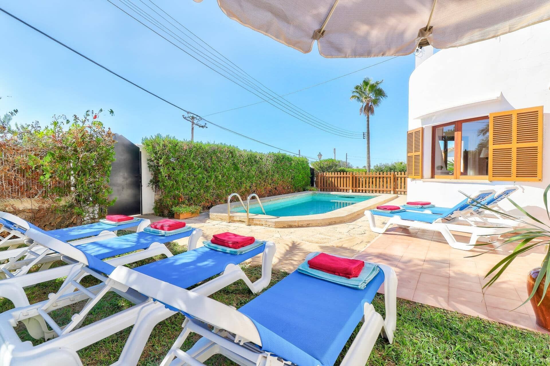 A poolside area with lounge chairs and a small pool.