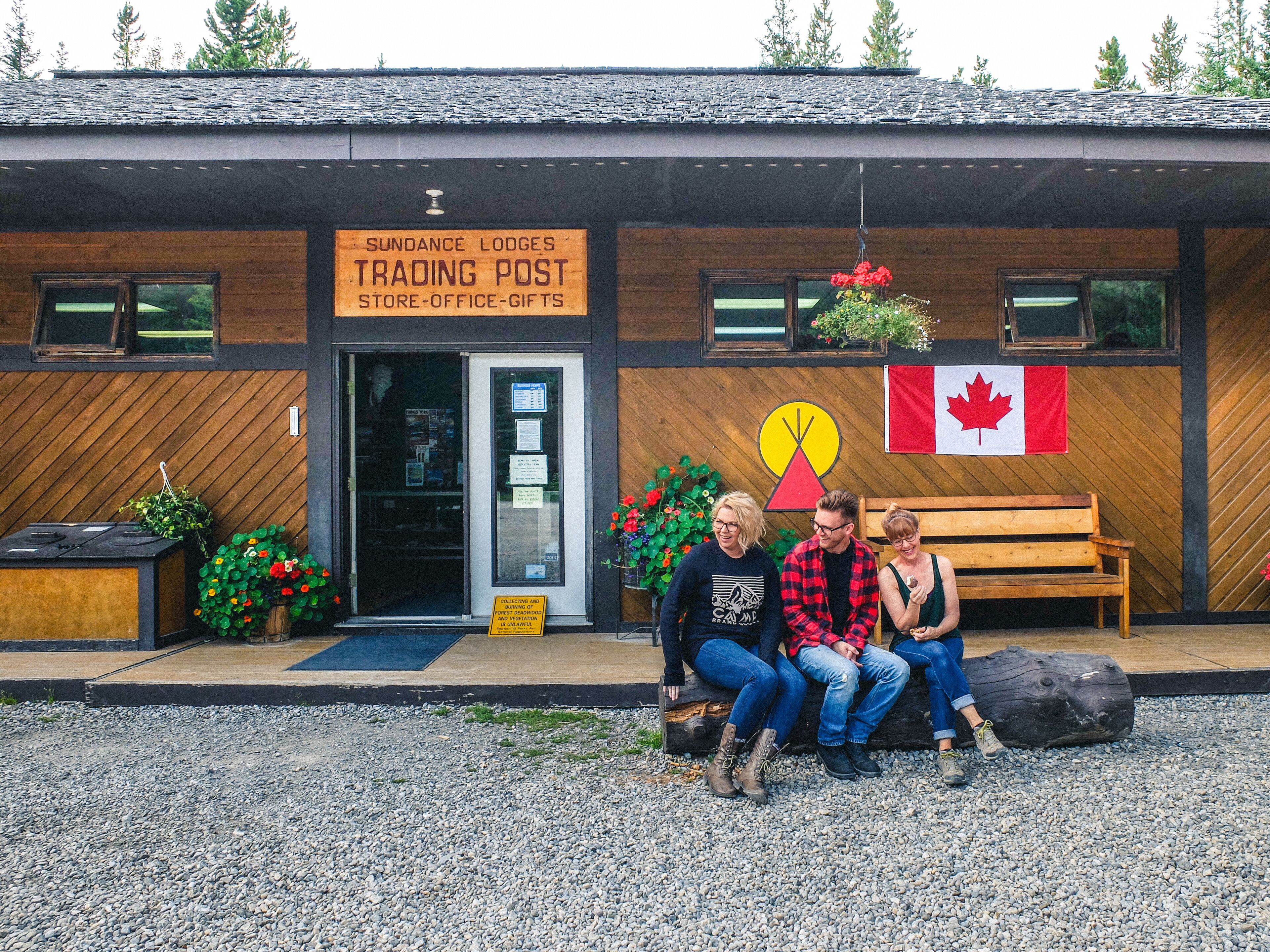 A wooden building with a sign for Sundance Lodges Trading Post.