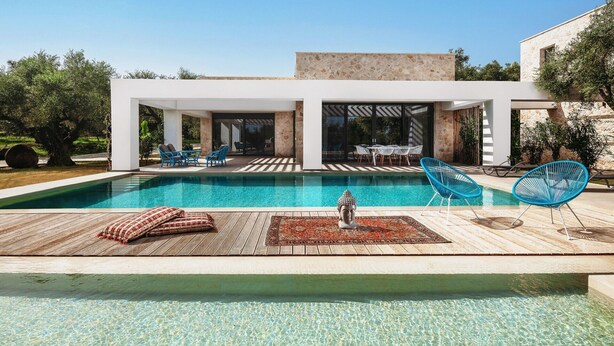 Une maison moderne dotée d’une piscine, d’un espace salon extérieur et d’une statue de Bouddha.