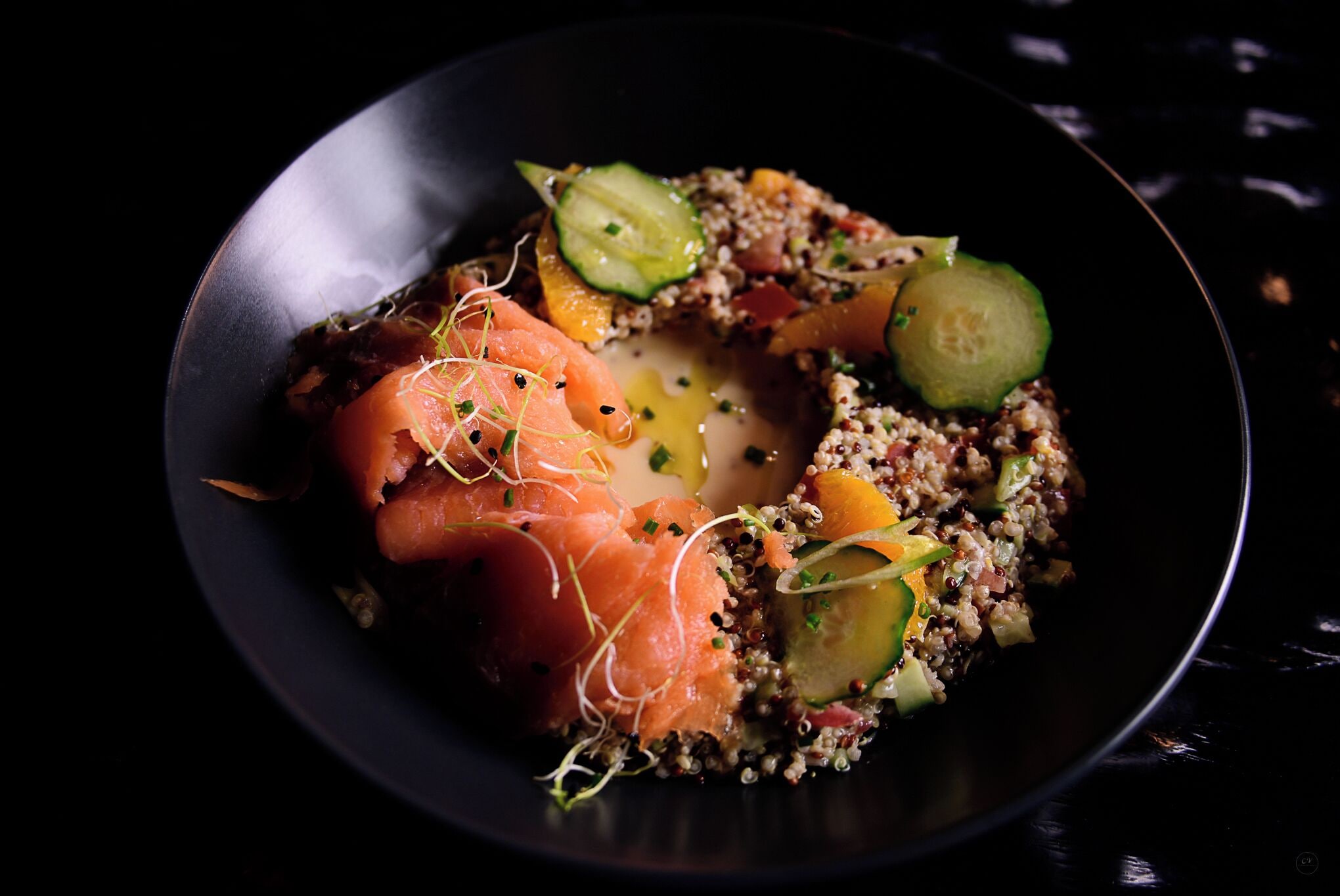 Un plato con salmón, quinua y verduras.