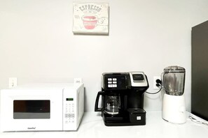 A kitchen with a coffee maker, a blender, and a microwave. - Spacious Stamford Home | Family, Work, Parking (Stamford)