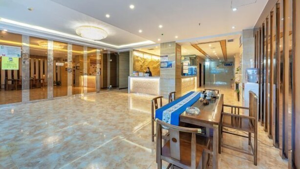 A spacious lobby with a reception desk, seating area, and a glass partition. - Towo Holiday Hotel (Libo Food Street) (Libo)