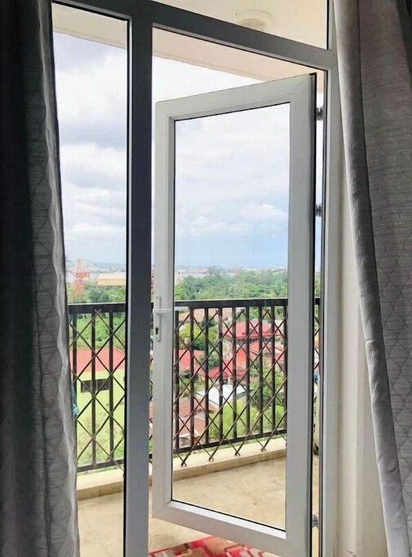 Enjoy the serene view of the surrounding residential area from this balcony.