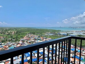 Enjoy breathtaking views of the coastal town from this balcony.