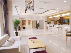 A hotel lobby with a reception desk, seating area, and a chandelier. - Greentree Inn Hefei Feidong County High Speed Rail Station Wuyue Plaza Express Hotel (Hefei)