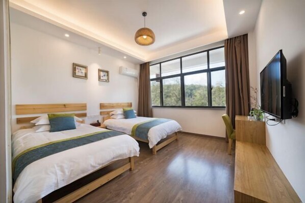 A hotel room with two beds, a TV, and a large window. - Xingwan Tianranju（South Entrance of Wuyi Mountain National Park） (Wuyishan)
