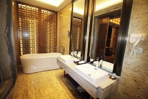 A modern bathroom with a freestanding bathtub, two sinks, and a large mirror. - Huazhushan Hotel (Weng'an County)