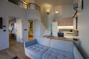 Relax in a cozy living area with a comfortable sofa and modern kitchen amenities.