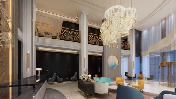 A modern lobby with a curved reception desk, seating areas, and a decorative chandelier. - Magnotel Hotel (Weinan Duhua Road Haixing City) (Weinan)
