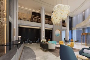 A modern lobby with a curved reception desk, seating areas, and a decorative chandelier. - Magnotel Hotel (Weinan Duhua Road Haixing City) (Weinan)