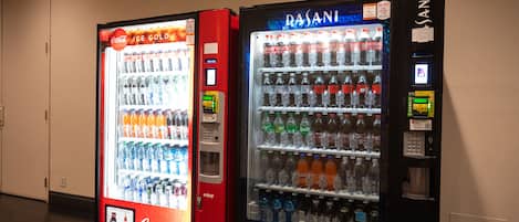 Two vending machines, one Coca-Cola and one Dasani, in a hallway.