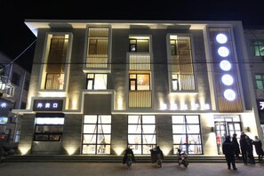 A modern building with large windows and a prominent entrance.