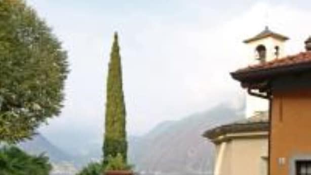 A table set outdoors with a view of mountains and a lake. - Vice King's Palace (Lezzeno)