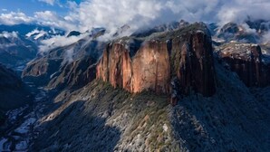 Paisaje montañoso con formaciones rocosas destacadas y un valle en la parte inferior.