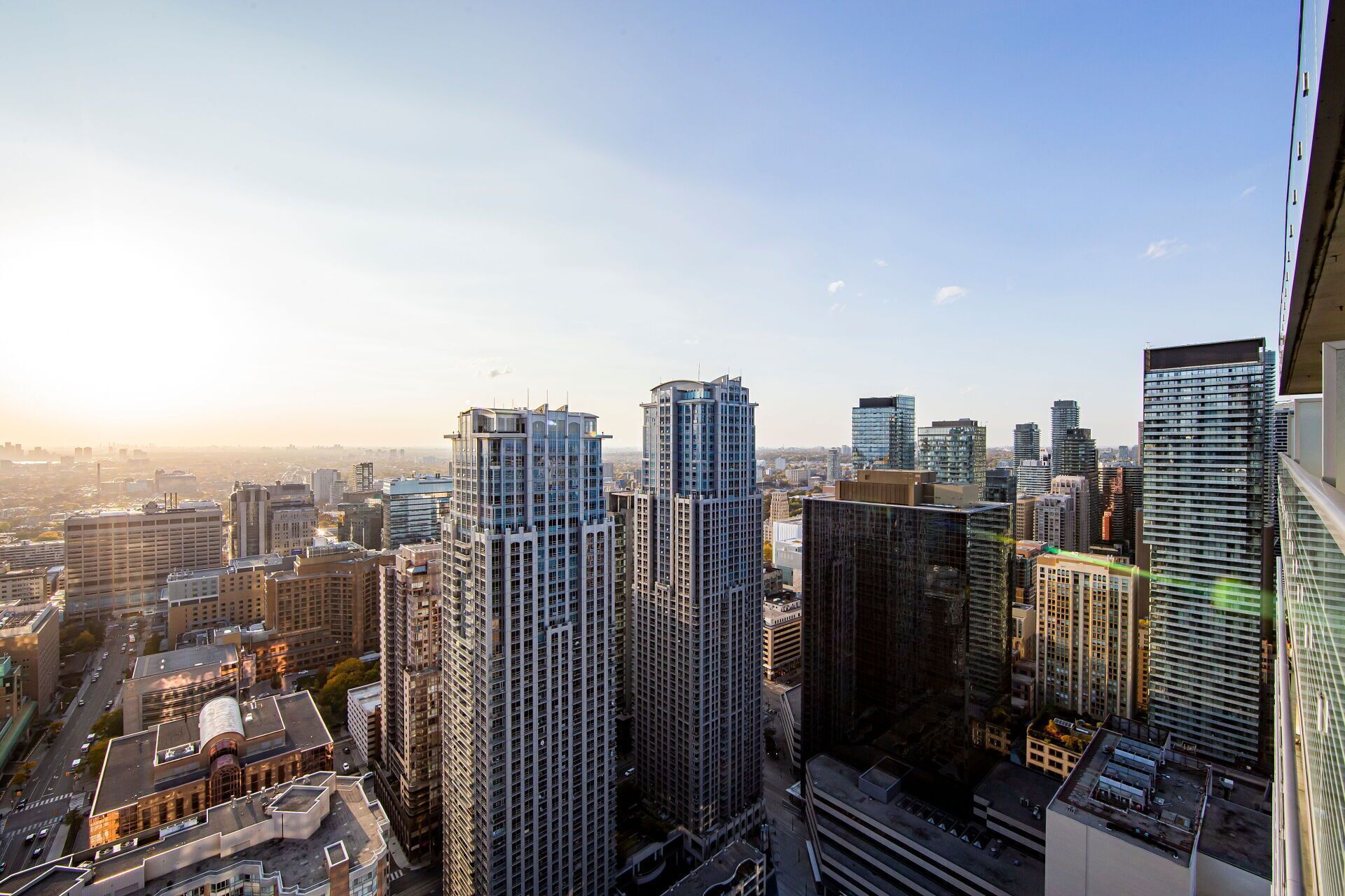 A high-rise urban area with modern skyscrapers, a clear sky, and a cityscape in the background.