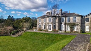 A large stone building with multiple windows and a well-maintained lawn. - Halecat House - Large Georgian House with Garden (Dog-friendly). (Witherslack)
