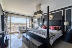 A modern bedroom with a large bed, a desk, and a balcony with a view. - Qingtian Yashe Inn (Tengchong)