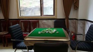 A room with a pool table, chairs, and a window with curtains. - Shennongjia Meets Miss Meow Hotel (Shennongjia)