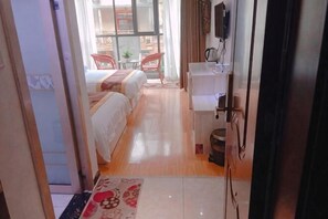 A hotel room with a bed, a desk, a chair, and a TV. - Shennongjia Meets Miss Meow Hotel (Shennongjia)