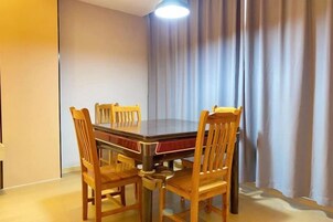 A dining area with a rectangular table and six wooden chairs.