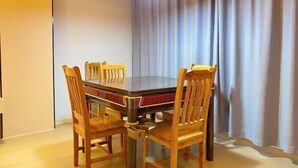 A dining area with a rectangular table and four wooden chairs. - Wanlonghote (Cenxi)