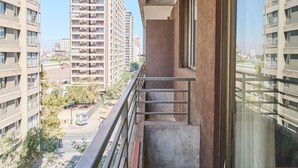 A balcony with a view of high-rise buildings, a tiled floor, and a glass door. - "Live life to the fullest in the heart of Santiago"! (Santiago)