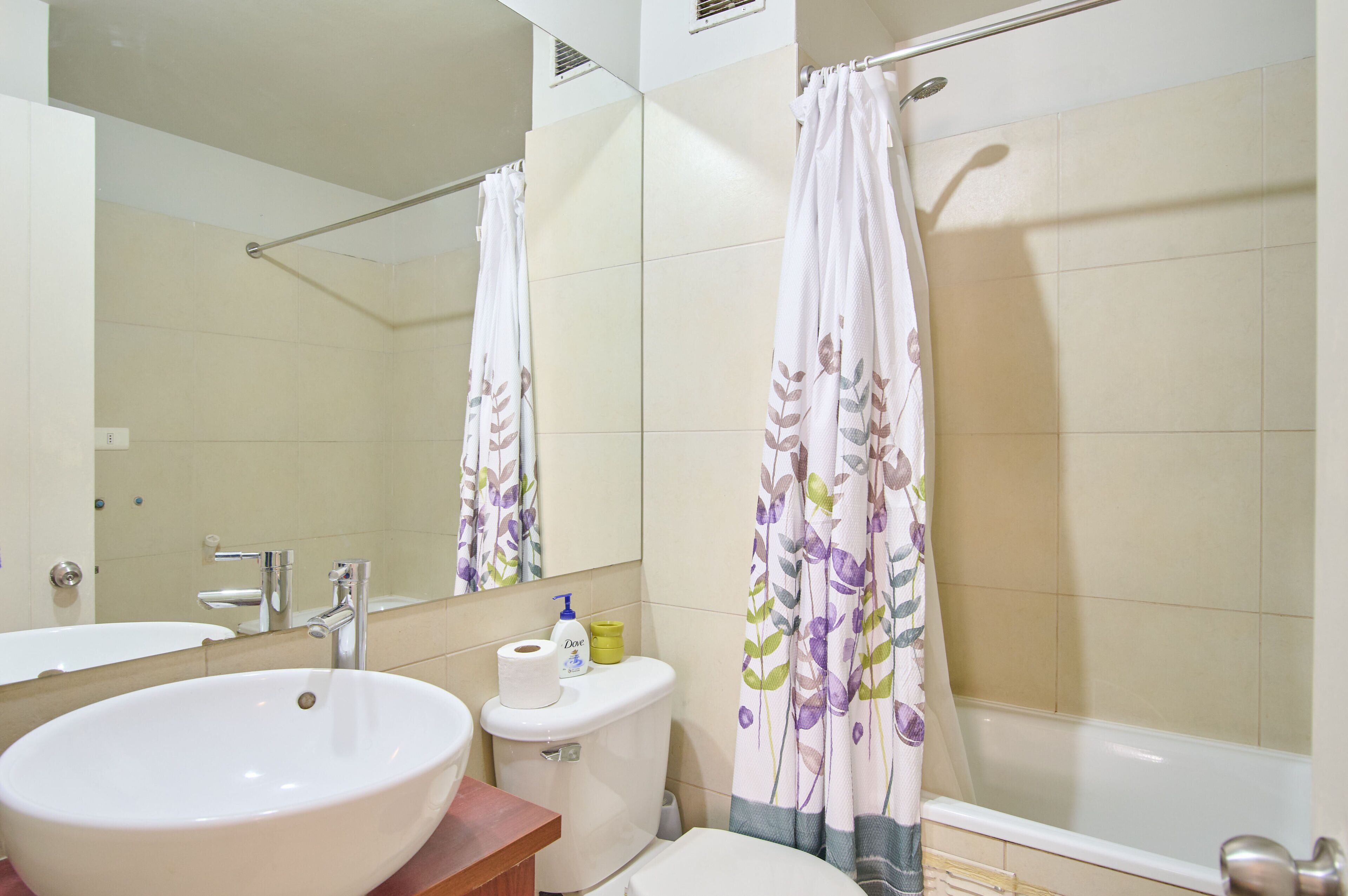 A bathroom with a large white sink, a toilet, and a bathtub.