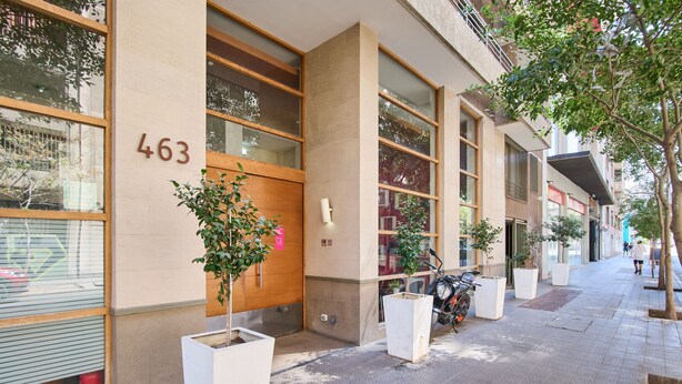 A building with the number 463 on its facade, large windows, and potted plants. - "Live life to the fullest in the heart of Santiago"! (Santiago)