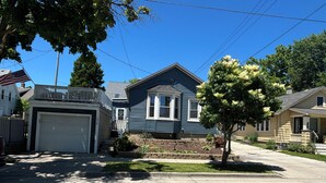 A residential street with houses, a garage, and a tree. - Bay View Gem (Milwaukee)