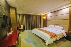 Relax in comfort with a large bed, flat-screen TV, and a desk for work or reading.