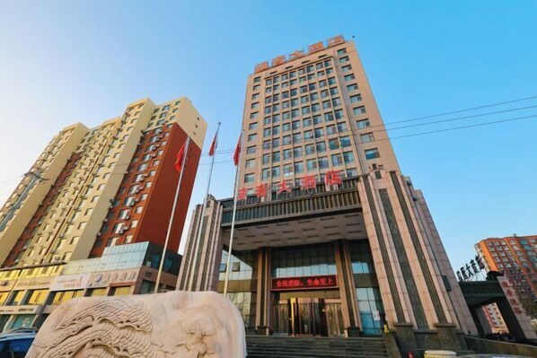 Stunning multi-story building with a grand entrance and ornate sculpture.
