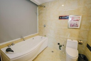 A bathroom with a bathtub, toilet, and a wall-mounted sink. - Boyin Hotel (Jiang County)