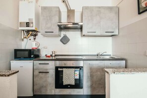 A modern kitchen with stainless steel appliances, a built-in oven, and a microwave.