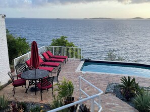 A poolside area with a view of the sea, outdoor furniture, and a small pool. - Secluded Oceanfront Villa with pool and incredible view! Welcome to Paradise! (St John)