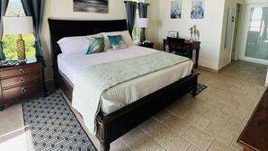 A bedroom with a large bed, a ceiling fan, and a view of the outdoors. - Secluded Oceanfront Villa with pool and incredible view! Welcome to Paradise! (St John)