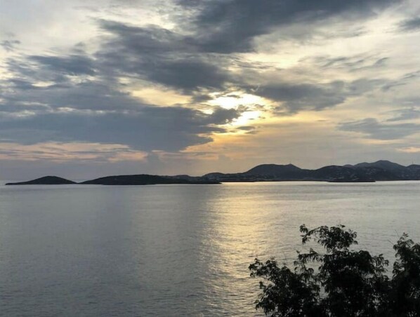 A calm body of water with distant landforms under a cloudy sky. - Secluded Oceanfront Villa with pool and incredible view! Welcome to Paradise! (St John)