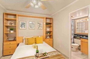Cozy retreat with a large bed, nightstands, and framed artworks adorning the walls.