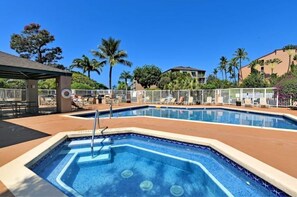 Relax by the pool surrounded by lush greenery and modern architecture.