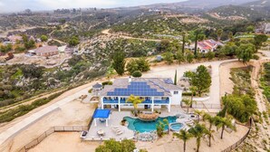 A large house with a swimming pool, solar panels, and a fenced patio area. - 5-acre Hilltop Estate w/ Resort Pool + Game Room Le Grand Bleu by Avantstay (Temecula)