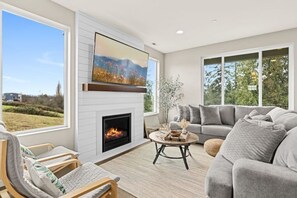 Cozy up in the living area with 70 inch smart TV and electric fireplace