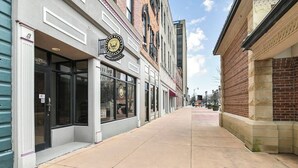 A street with a building featuring a large storefront with a sign that reads "The Olde Town Inn."