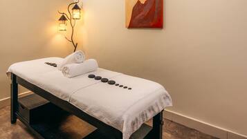 Experience rejuvenation in this serene spa treatment room, featuring a massage table and soothing ambiance.