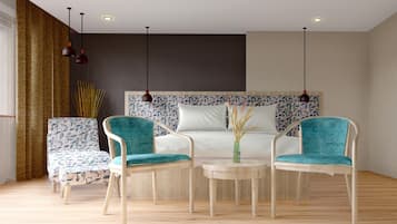 A modern room with a sofa, two armchairs, a small table, and a decorative vase.