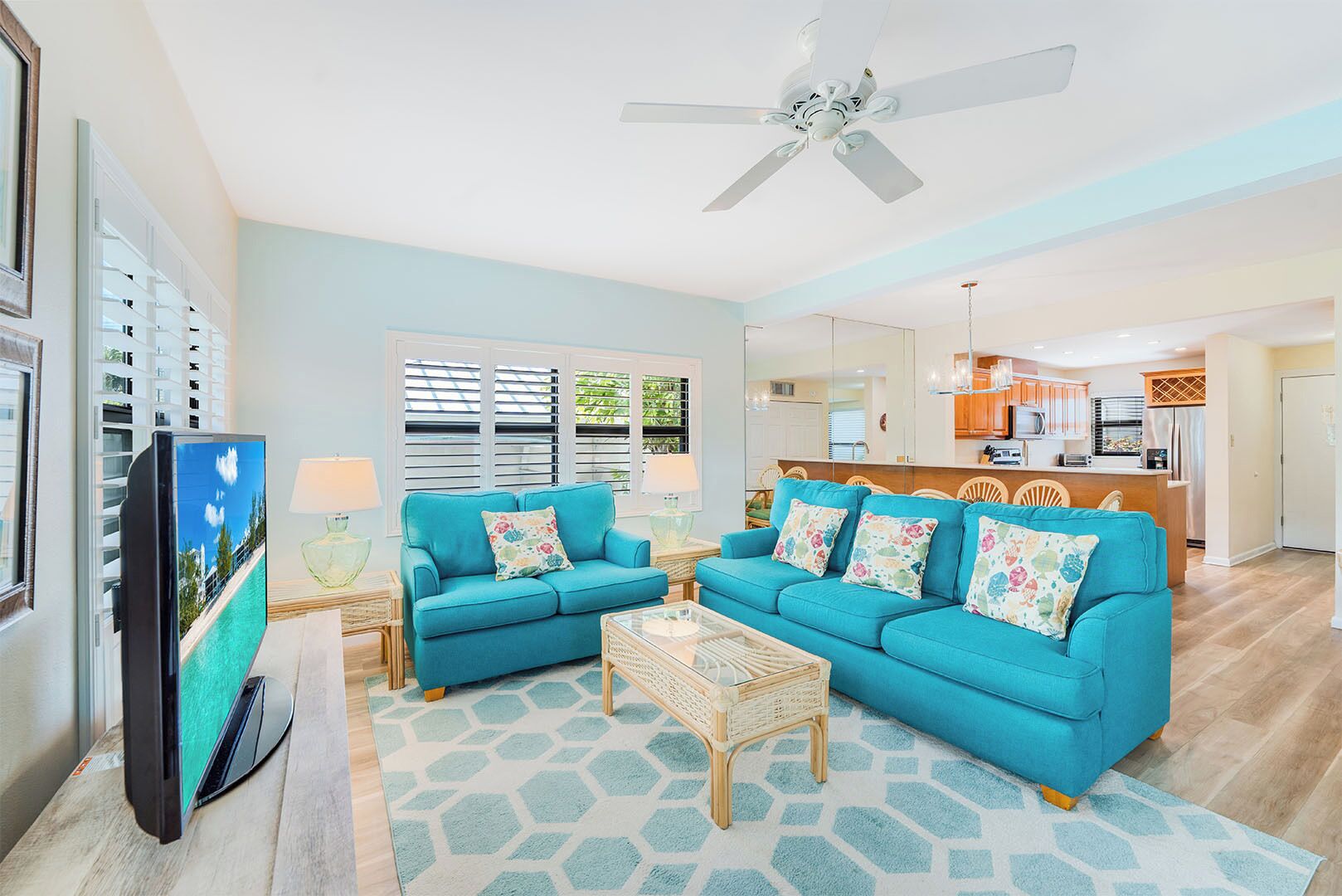 A living room with a sofa set, a coffee table, and a television.