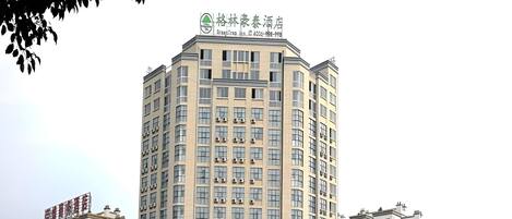 A multi-story hotel with a prominent sign at the top.