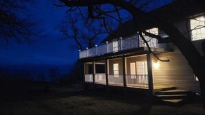 A two-story house with a balcony and a covered porch. - Lakehouse Vineyard on Lake Erie! (Ripley)